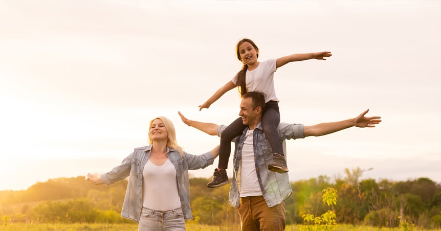 Middle aged couple holding hands out in heart shape